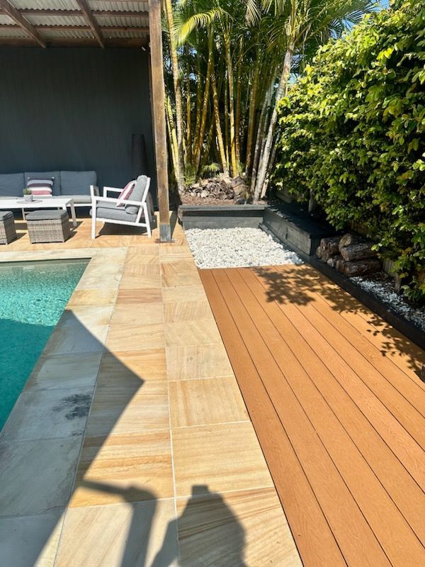Modern composite decking around a pool area, showcasing water-resistant and low-maintenance materials.