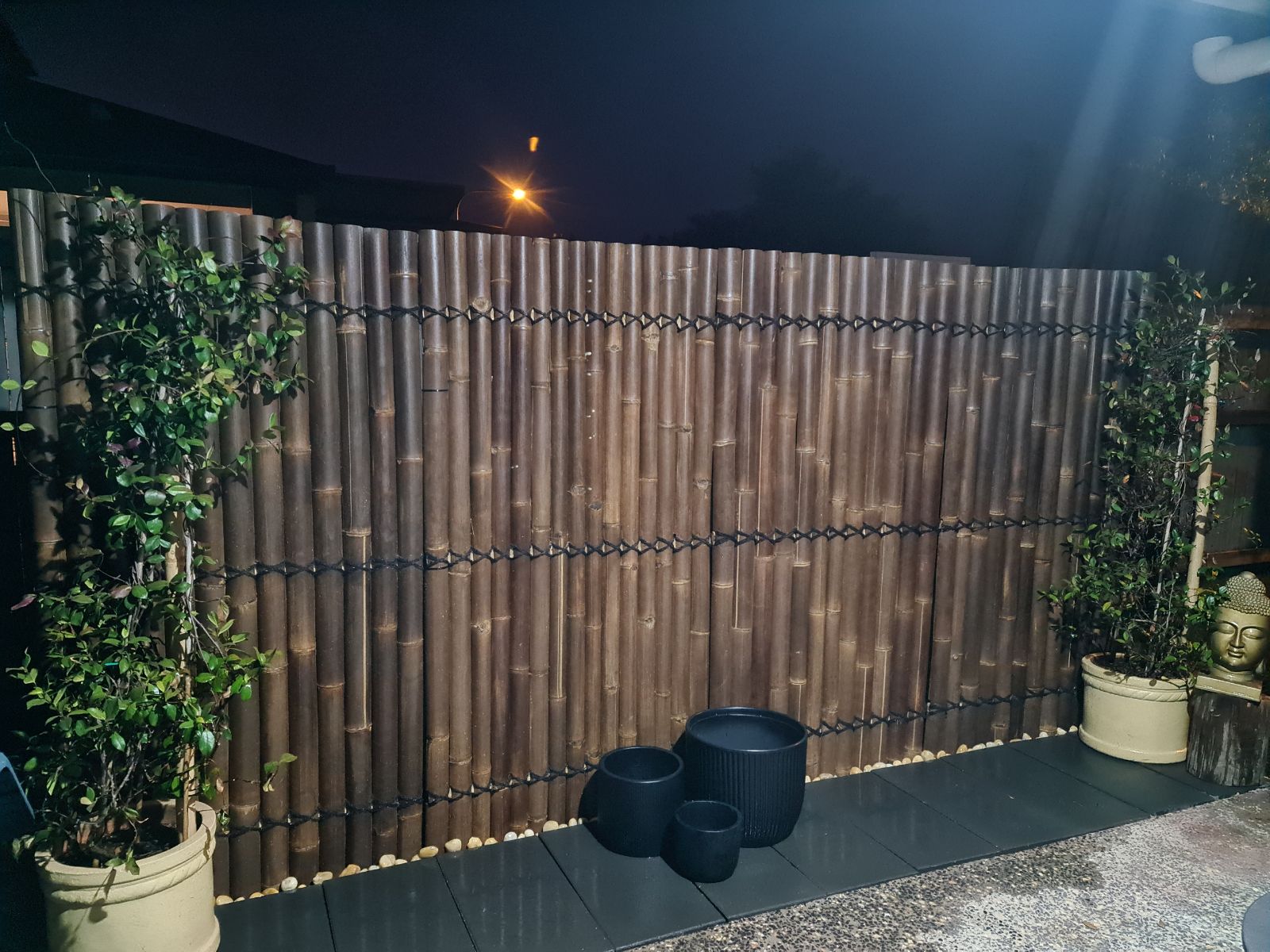 screening lit at night in a garden 