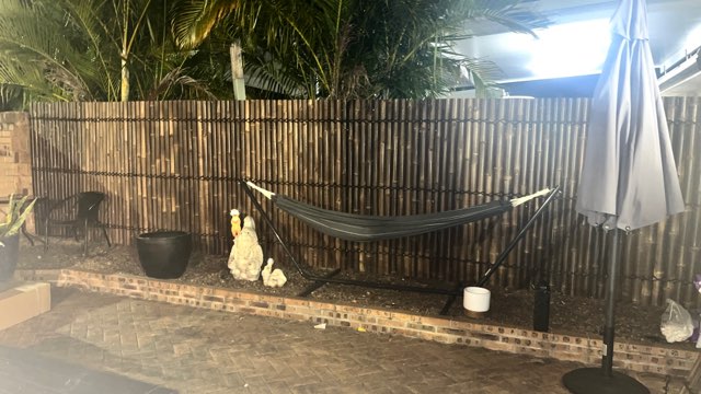 bamboo fence with a hammock in front