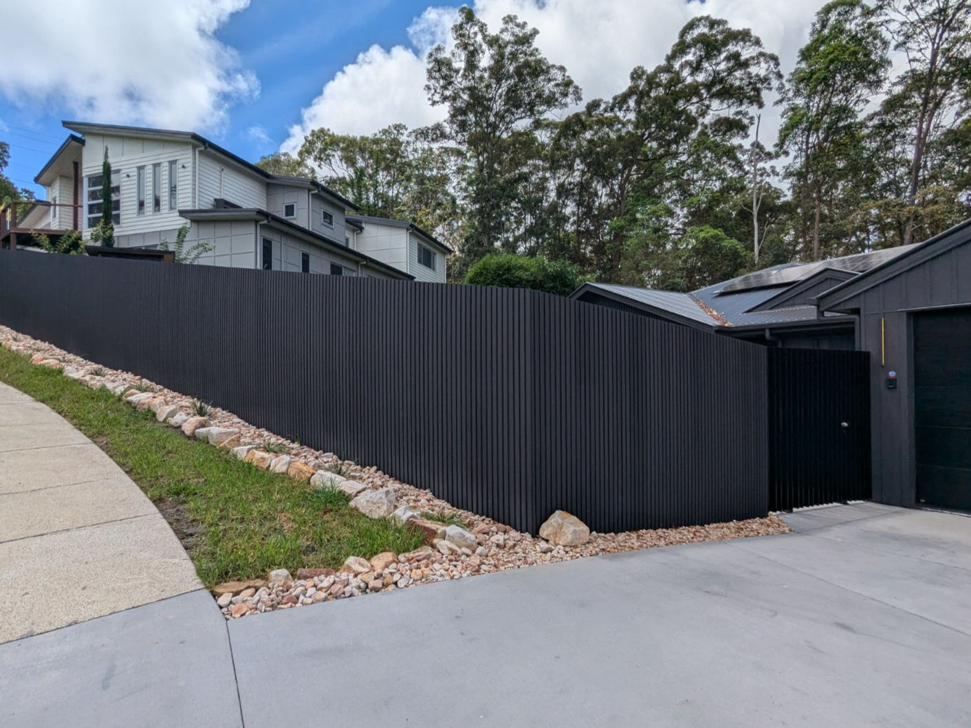 an attractive fence is built using Wpc cladding in monument color. very sleek and stylish.