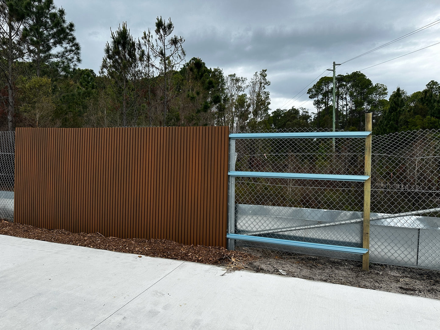 an example of the wpc panels being installed with steel rails, this is best practice.